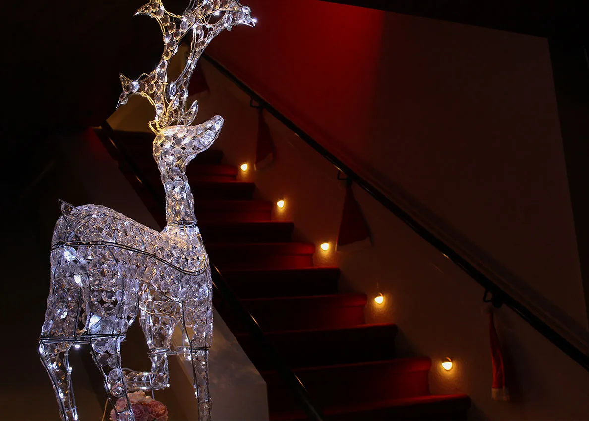 Staircase that leads to the underground Rubens Bar with glowing reindeer