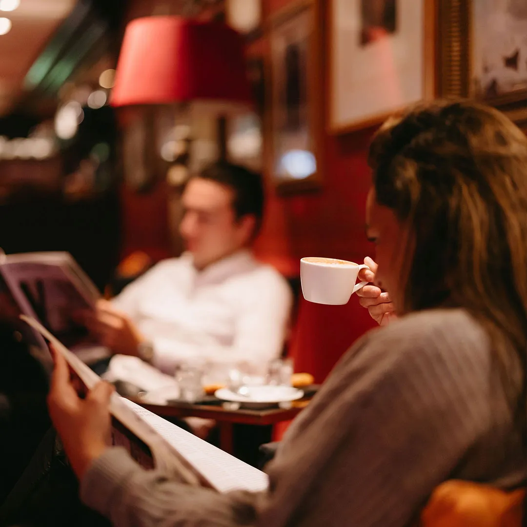 Man and woman enjoying a cup of coffee in the Sophia Lounge